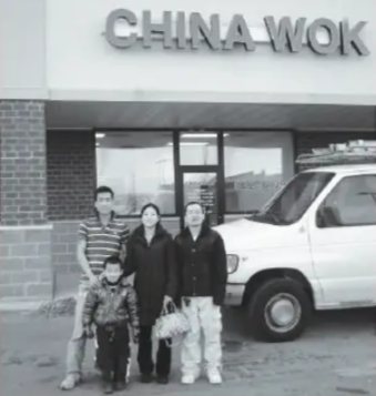 The family standing in front of China Wok, next to the delivery van